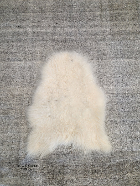 ONE OF THE KIND Icelandic White Sheepskin - Black Sheep (White Light)