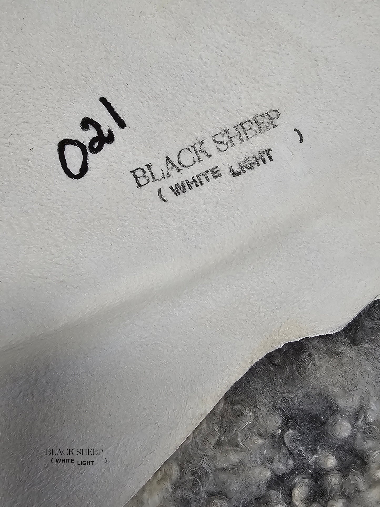 ONE OF THE KIND Gotland White and Grey Medium Wool Sheepskin - Black Sheep (White Light)