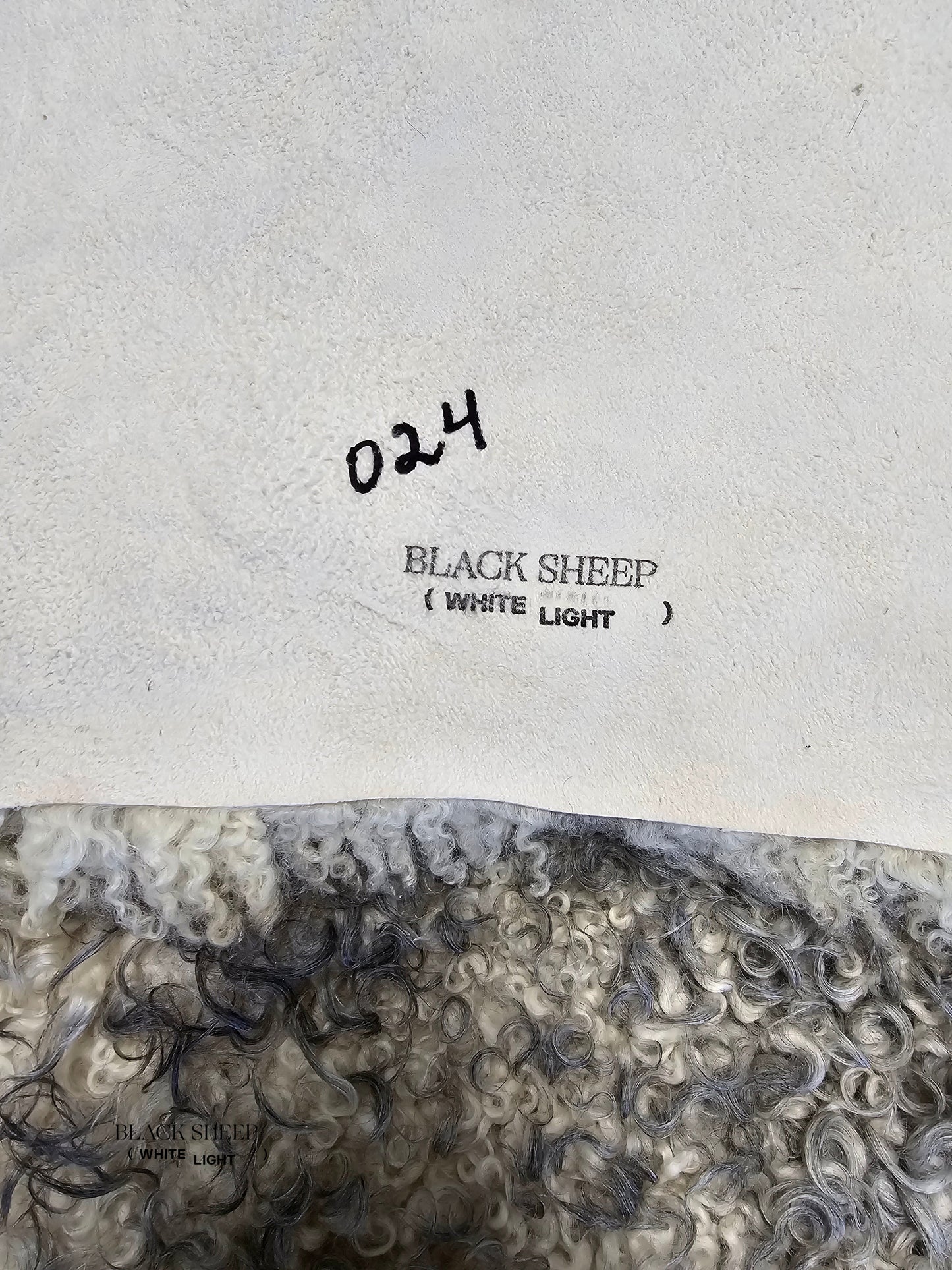 ONE OF THE KIND Gotland White and Grey Medium Wool Sheepskin - Black Sheep (White Light)