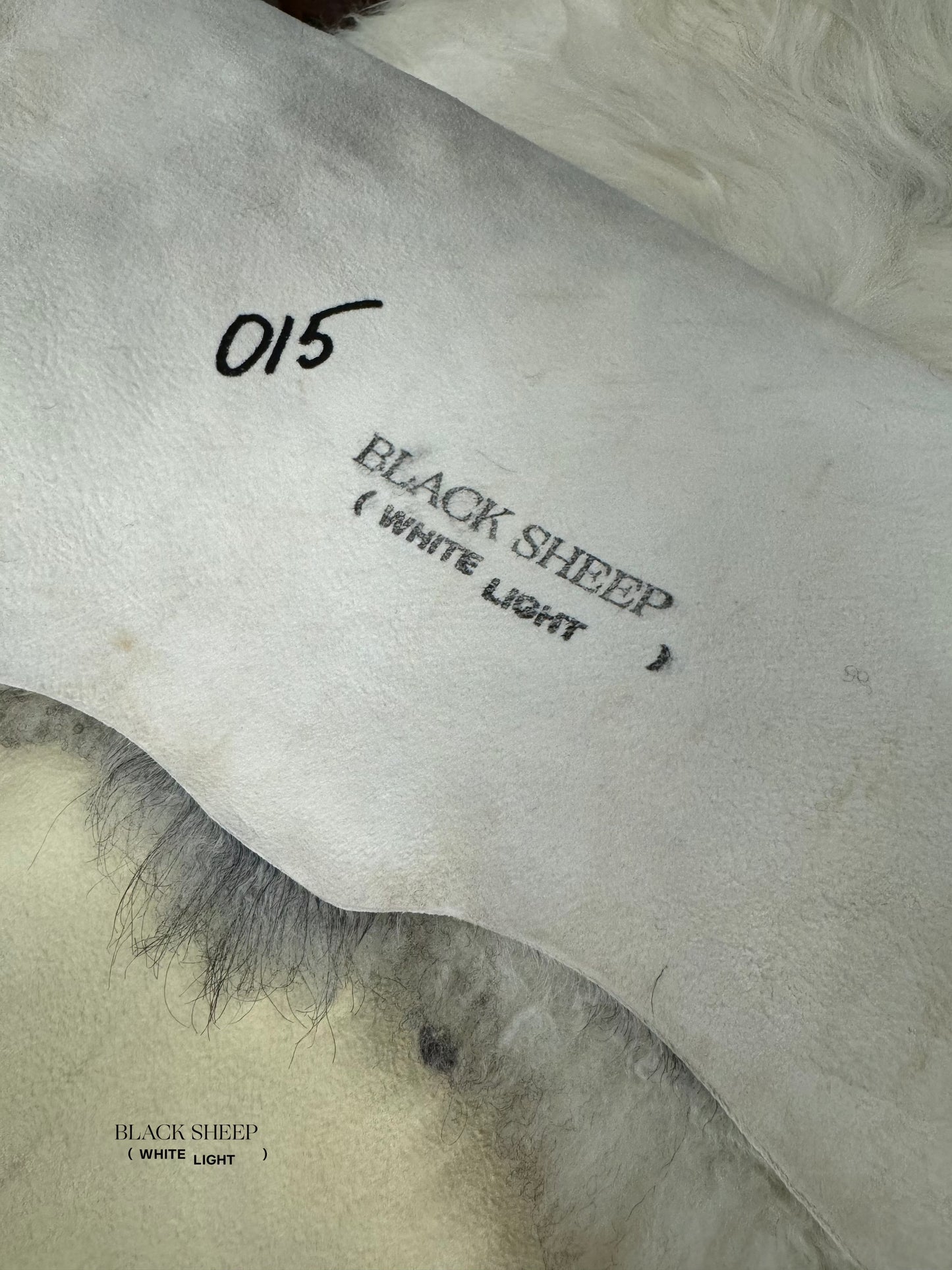 ONE OF THE KIND Gotland White and Grey Medium Wool Sheepskin - Black Sheep (White Light)
