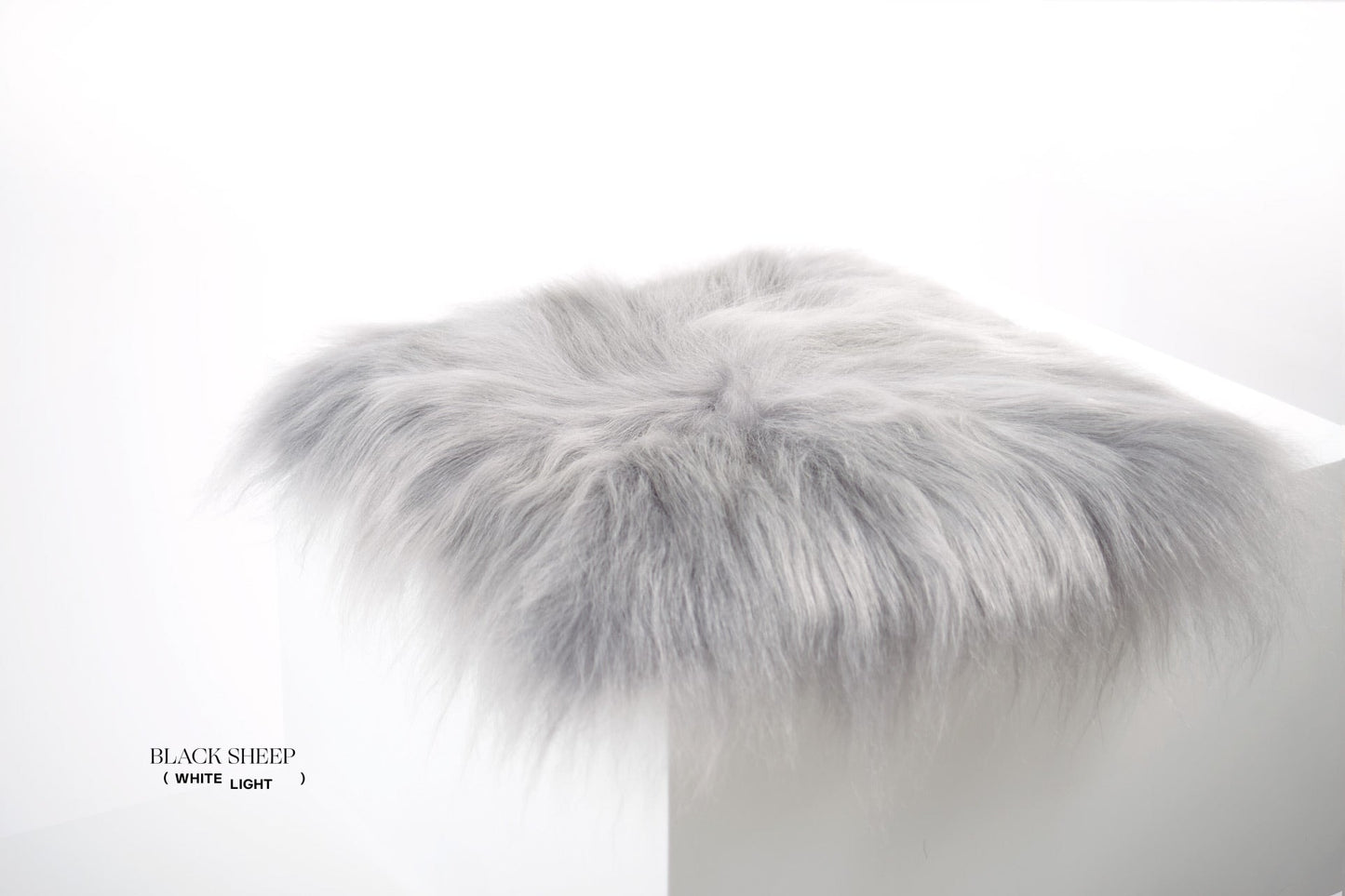 Silver Icelandic Sheepskin Chair Pad - Black Sheep (White Light)